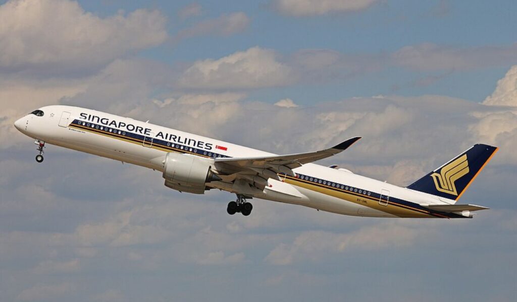 Singapore Airlines Airbus A350‑900ULR climbing after take‑off against a cloudy sky.
